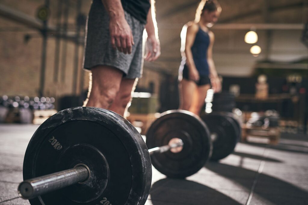 Woman and man practicing weight training, showing how strength workouts can be used as exercise for public speaking anxiety to build focus and confidence.