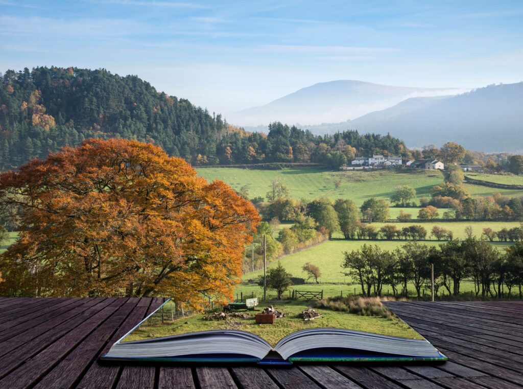 An open book with a beautiful landscape emerging from its pages, symbolizing how storytelling in speeches brings ideas to life and inspires imagination.