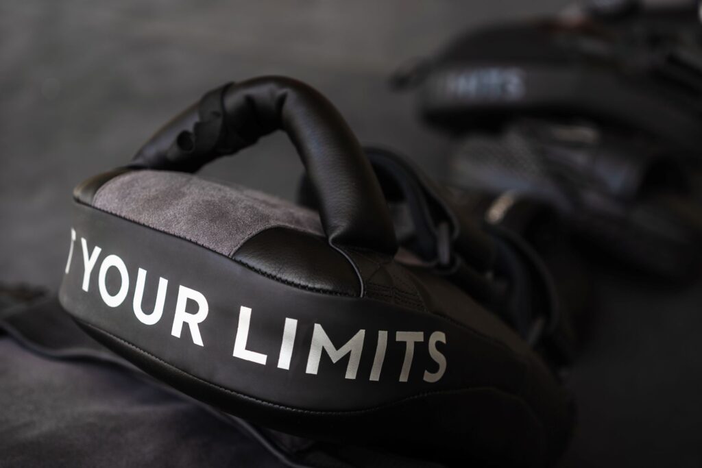 Boxing gloves with 'Your Limits' text, symbolizing training like an athlete to overcome fear of public speaking and build confidence.