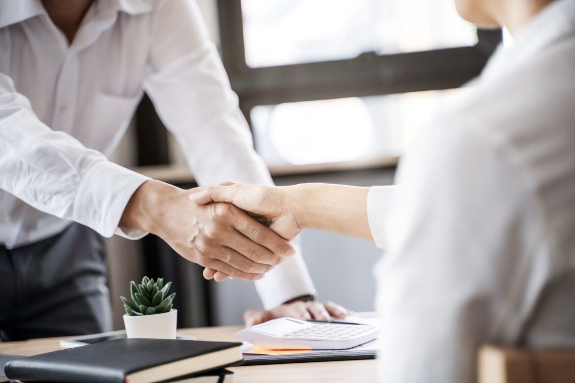 Professional handshake at a job interview, showing succesful outcome when implementing these job interview presentation tips.