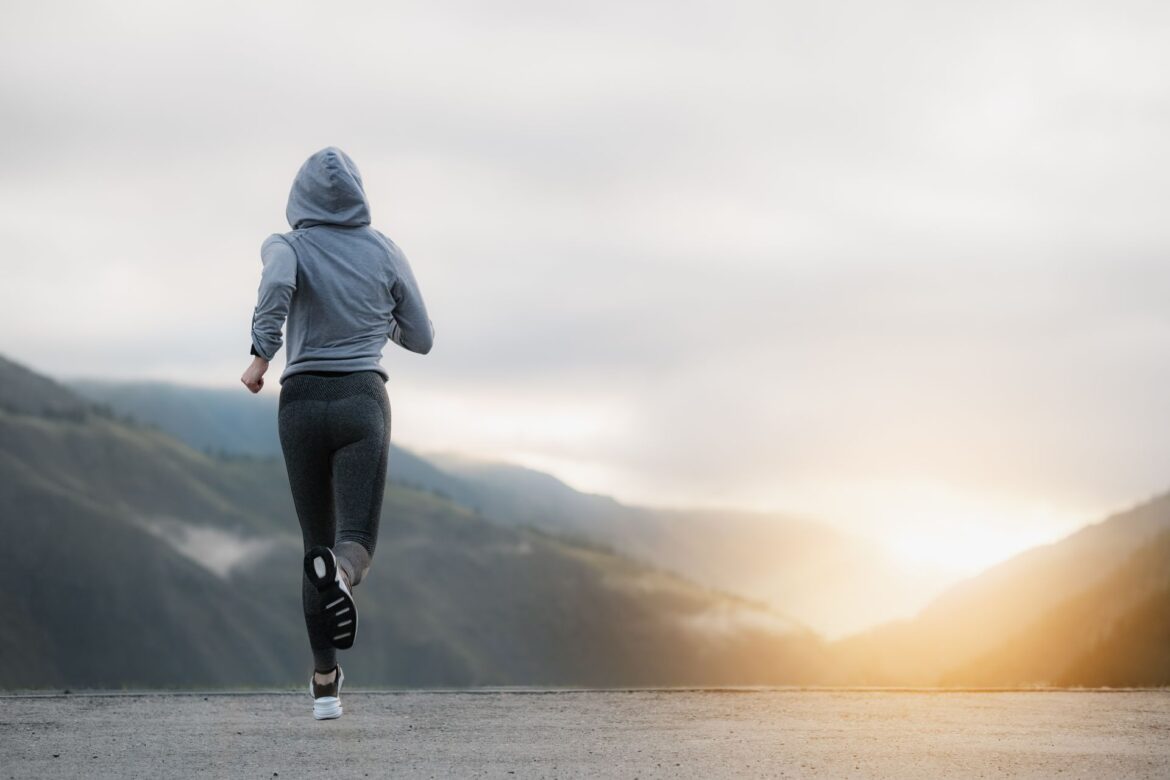 Woman running at sunrise, showing how exercise for public speaking builds confidence and reduces pre-speech nerves.